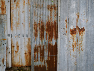 Galvanized fence wall is rusty.