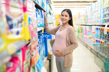 Pregnant woman shopping newborn products in the mall