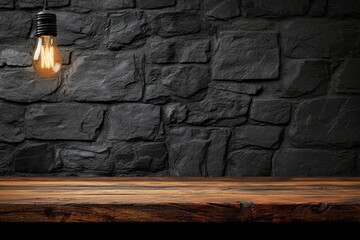 Glowing bulb illuminates rustic wooden table against dark stone wall background.