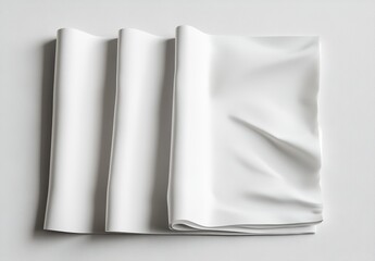 Three blank white papers, crumpled, rolled, and stacked on a white background.