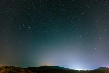 Fototapeta premium Background of the tourist attraction Wat Sirindhorn Wararam or the famous glowing temple in Thailand. Ubon Ratchathani is adjacent to Laos. Tourists always like to come to see the beauty at night.