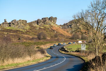 UPPER HULME, STAFFORDSHIRE, ENGLAND - JANUARY 30 2025: Cars on the A53 Leek to Buxton road passing Ramshaw Rocks.