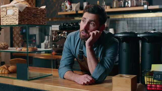 Tired bored Caucasian male entrepreneur cafeteria worker man feel exhausted sad in coffee shop barista small business owner problem no clients restaurant crisis upset waiter guy waiting for customers