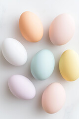 Pastel-colored Easter eggs are arranged harmoniously on a clean white surface, showcasing a tranquil decorative theme. This serene setup conveys a celebratory spirit that enhances spring celebrations