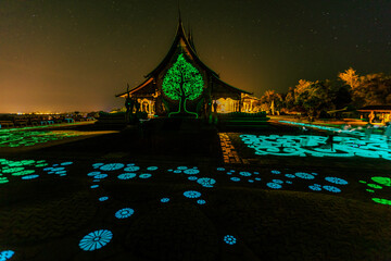 Background of the tourist attraction Wat Sirindhorn Wararam or the famous glowing temple in Thailand. Ubon Ratchathani is adjacent to Laos. Tourists always like to come to see the beauty at night.