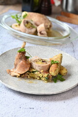 Close-up of a traditional spring dish – rabbit loin stuffed with a fragrant herb filling. The tender meat is sliced to reveal the delicious stuffing, highlighting the rustic yet elegant presentation. 