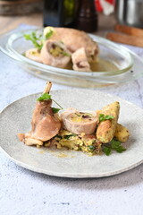 Close-up of a traditional spring dish – rabbit loin stuffed with a fragrant herb filling. The tender meat is sliced to reveal the delicious stuffing, highlighting the rustic yet elegant presentation. 