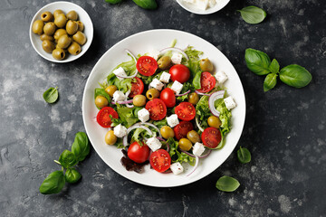 Fresh Mediterranean salad with feta cheese, tomato, olives, onion and basil leaves, Healthy food