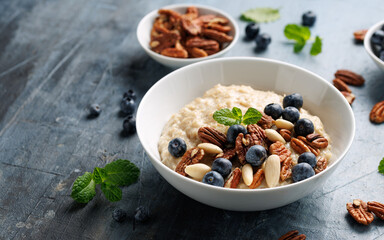 Oatmeal porridge with blueberry, almonds, and pecan healthy food breakfast.