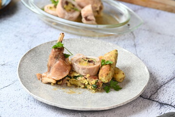 Close-up of a traditional spring dish – rabbit loin stuffed with a fragrant herb filling. The tender meat is sliced to reveal the delicious stuffing, highlighting the rustic yet elegant presentation. 