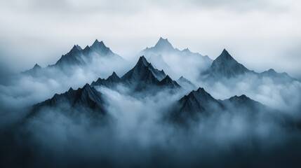 Obraz premium Majestic Mountain Peaks Emerging from Dense Fog and Clouds
