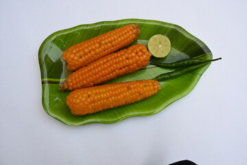 Boiled sweet corn on the plate. This is a complete food for humans. It contains many vitamins, such as Vitamin B1, B5, C, B9, E, A. Boiled corn on the cob. It's like all over world.  Heathy eating. 