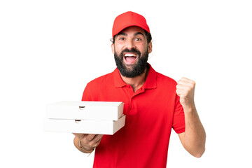 Pizza delivery man with work uniform picking up pizza boxes over isolated chroma key background...
