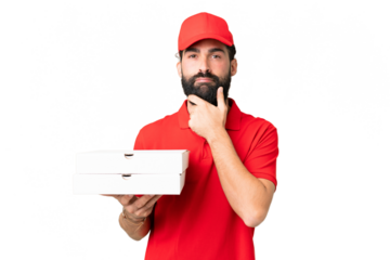 Pizza delivery man with work uniform picking up pizza boxes over isolated chroma key background thinking