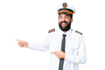 Airplane caucasian pilot man over isolated chroma key background surprised and pointing side