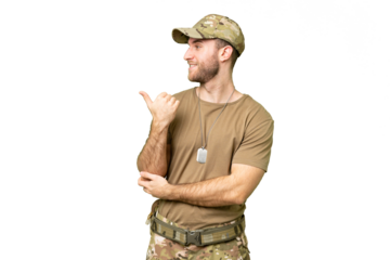 Military with dog tag over isolated chroma key background pointing to the side to present a product