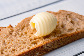 Butter that adds flavor to meals and is for breakfast on white wooden  background