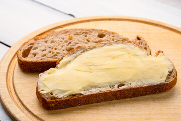 Butter that adds flavor to meals and is for breakfast on white wooden  background