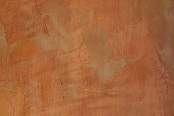 The wall surface is painted bright orange with abstract shapes and colors.
