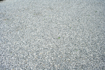 A textured surface of small gray stones creates a natural and versatile background, suitable for various design projects.
