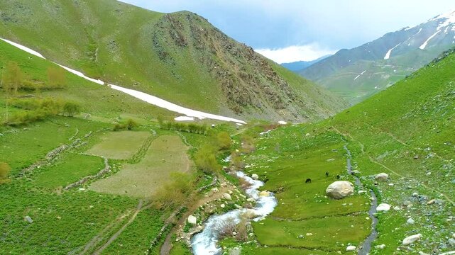 Aerial view of the valley, Parwan Province , Afghanistan, river and grass, in the spring, in daylight.