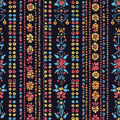 Vibrant floral pattern on a dark background featuring colorful flowers and decorative elements.