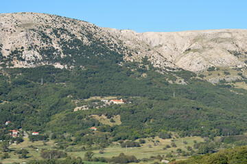 Obraz premium Nestled amidst a lush, verdant landscape, the Sanctuary of the Mother of God of Gorica (Svetiste Majke Bozje Goricke) stands prominently in the center of the image, on Island Krk in Croatia