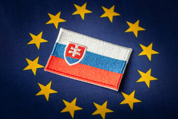 The symbol of Slovakia placed in the middle of the European Union flag. Political Concept. Difficult cooperation of Slovakia with the EU countries.