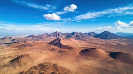 Fototapeta premium Aerial View of Dramatic Desert Landscape Under a Vivid Blue Sky