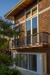 Fototapeta premium Modern House Exterior with Balcony and Garden View. Beautiful Contemporary Home Design, Real Estate Photography