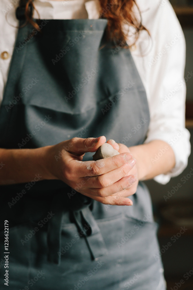 Poster process of creating ceramic products. potter holds a piece of wet clay in their hands, molds it into