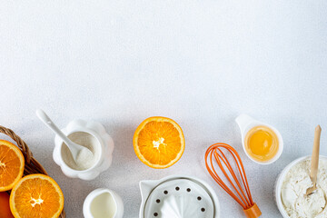 Concept homemade fall baking with oranges, food ingredients, spices and kitchen utensil.