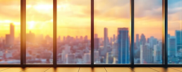 Sunlit urban skyline view through large glass windows at sunset