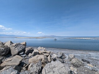 Scenic View of the Great Salt Lake with Rocky Shoreline and Clear Blue Sky.