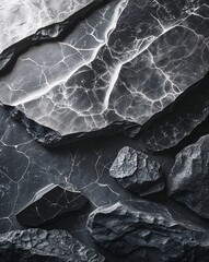 Black and silver polished stone surfaces with soft glowing radiance abstract stone rocks nature concept background
