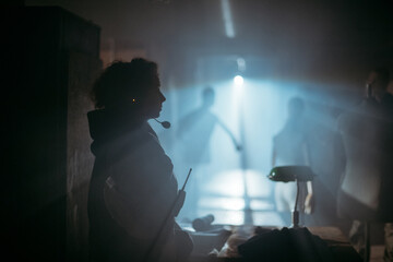 A female director at work on the set. The director works with a band or with a speaker during the...