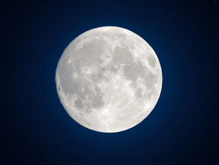 A large, full moon is shining brightly in the night sky