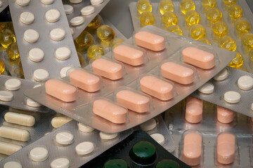 Close-up of various tablets and pills arranged in a disorganized manner