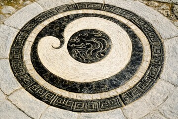 Obraz premium Stone spiral design pathway garden detail.