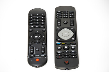 Two remote controls for home entertainment devices on a white background