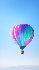 Fototapeta premium Colorful hot air balloon floats in clear blue sky above a misty landscape; ideal for travel brochures
