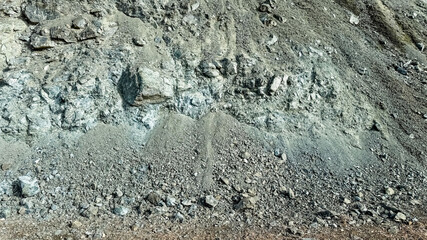 Rugged rocky cliff with loose gravel depicting erosion and natural landscape challenges, ideal for geology and earth science themes
