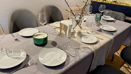 Elegant dining table set for a festive Christmas Eve dinner, showcasing a cozy and welcoming holiday atmosphere