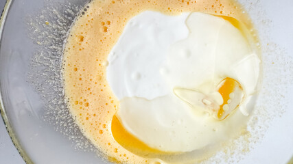 Bowl of mixed eggs and milk representing breakfast preparation or holiday baking, emphasizing the concept of cooking creativity