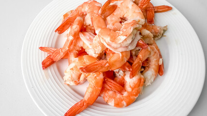 A delicious plate of cooked shrimp, perfect for seafood enthusiasts and summer cookouts, showcasing fresh culinary delight