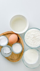 Baking ingredients set on a white background, ideal for Christmas dessert preparation or illustrating culinary creativity concepts