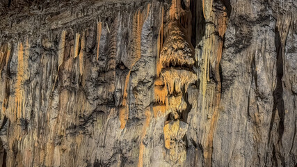 Stalactites and stalagmites create a stunning natural rock formation inside a cave, highlighting geological wonders and adventure travel