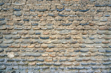 The surface of the earthen wall is made of tiles.