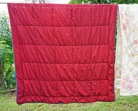 red blanket hanging on a clothesline