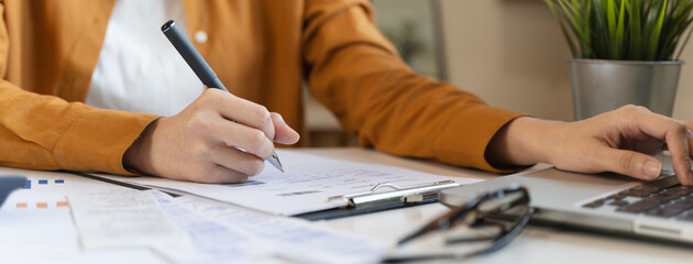 person using calculator calculating tax refund on the table